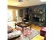 Stylish living room featuring a stone fireplace, wood floors, and comfortable seating at 2121 Suzanne Dr, Mount Dora, FL 32757