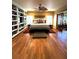 Spacious main bedroom with hardwood floors, built-in shelving, ceiling fan, and ample natural light at 2121 Suzanne Dr, Mount Dora, FL 32757