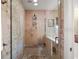 Modern tiled shower with glass door, built-in bench, and updated showerhead at 2121 Suzanne Dr, Mount Dora, FL 32757