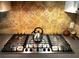Modern stainless steel stovetop with a decorative tile backsplash at 2121 Suzanne Dr, Mount Dora, FL 32757