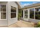 Back exterior view showing the screened lanai, back porch and landscaping at 2204 Margarita Dr, The Villages, FL 32159