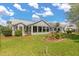 Back exterior view showing the back porch and Florida room at 2204 Margarita Dr, The Villages, FL 32159