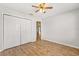 Empty bedroom with a ceiling fan, hardwood floors, and a closet at 2204 Margarita Dr, The Villages, FL 32159