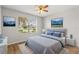 Comfortable bedroom with a large window, artwork, and a plush bed at 2204 Margarita Dr, The Villages, FL 32159