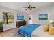 Bright bedroom features modern decor, a large window with views, and a ceiling fan at 2204 Margarita Dr, The Villages, FL 32159