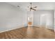 Spacious bedroom with wood-look flooring, a ceiling fan, and access to a bathroom and closet at 2204 Margarita Dr, The Villages, FL 32159