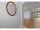 The foyer features wood flooring and a decorative mirror that adds charm and complements the interior's design at 2204 Margarita Dr, The Villages, FL 32159