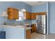 Charming kitchen with stainless steel appliances and wooden cabinets providing ample storage space at 2204 Margarita Dr, The Villages, FL 32159