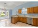 Open-concept kitchen with oak cabinets, tile floors, and a bright atmosphere at 2204 Margarita Dr, The Villages, FL 32159