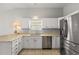 Kitchen with stainless steel refrigerator, window over sink, and plenty of storage space at 2204 Margarita Dr, The Villages, FL 32159