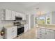 Open kitchen design with stainless steel appliances, tiled floor, and breakfast nook at 2204 Margarita Dr, The Villages, FL 32159