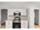 Close-up of a kitchen equipped with modern appliances and sleek, white cabinetry at 2204 Margarita Dr, The Villages, FL 32159