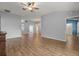 Open-concept living area showcases the layout with wood floors, a chandelier, and access to other living spaces at 2204 Margarita Dr, The Villages, FL 32159