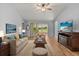 Cozy living room with comfortable seating, wood floors, and a view of the outdoors, perfect for relaxation at 2204 Margarita Dr, The Villages, FL 32159