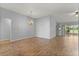Spacious living room with vaulted ceilings, a chandelier, wood floors, and sliding doors to the outdoors at 2204 Margarita Dr, The Villages, FL 32159