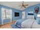 Comfortable bedroom featuring a ceiling fan and large windows allowing natural light at 2204 Margarita Dr, The Villages, FL 32159