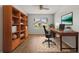Inviting home office with built-in bookshelves, a spacious desk, and ample natural light at 2204 Margarita Dr, The Villages, FL 32159