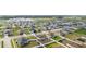Aerial view showcasing a neighborhood of single-Gathering homes, manicured lawns, and community streets at 2256 Gladiolus Ln, Mascotte, FL 34753
