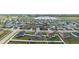Aerial view showcasing a neighborhood of single-Gathering homes, manicured lawns, and community streets at 2256 Gladiolus Ln, Mascotte, FL 34753
