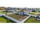 Back aerial view of a property with a large fenced in back yard at 2256 Gladiolus Ln, Mascotte, FL 34753