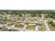 Aerial view of a residential community featuring manicured lawns, sidewalks and various home styles at 2256 Gladiolus Ln, Mascotte, FL 34753