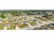 Aerial view showcasing a neighborhood of single-Gathering homes, manicured lawns, and community streets at 2256 Gladiolus Ln, Mascotte, FL 34753