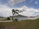 View of home's backyard with solar panels, showcasing a pristine white fence and well-kept lawn at 2256 Gladiolus Ln, Mascotte, FL 34753