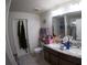 Functional bathroom with dual sinks, granite countertops, and ample storage space at 2256 Gladiolus Ln, Mascotte, FL 34753