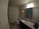 Cozy bathroom with granite countertop, single sink, and shower with curtain at 2256 Gladiolus Ln, Mascotte, FL 34753