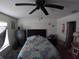 Bedroom with ceiling fan, dresser, and access to a cat play area at 2256 Gladiolus Ln, Mascotte, FL 34753