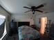 Bedroom with ceiling fan, dresser, and access to a cat play area at 2256 Gladiolus Ln, Mascotte, FL 34753