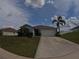 Well-kept single Gathering home with a lush front lawn and two-car garage at 2256 Gladiolus Ln, Mascotte, FL 34753