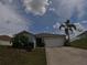 Charming single-story home with a well-maintained lawn and two-car garage at 2256 Gladiolus Ln, Mascotte, FL 34753