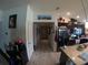 Open kitchen with stainless steel appliances and an adjacent hallway at 2256 Gladiolus Ln, Mascotte, FL 34753