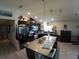 Bright, open kitchen featuring a large granite island and modern appliances at 2256 Gladiolus Ln, Mascotte, FL 34753