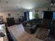 Spacious living room with a sectional sofa, fish tank, and modern accents at 2256 Gladiolus Ln, Mascotte, FL 34753