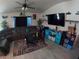 Cozy living room with ceiling fan, comfortable seating, and modern decor at 2256 Gladiolus Ln, Mascotte, FL 34753