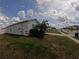 A view of the home's side yard, a healthy lawn, and a glimpse of the friendly neighborhood at 2256 Gladiolus Ln, Mascotte, FL 34753