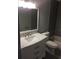 Updated bathroom featuring modern vanity with marble countertop, dark gray walls and bathtub with tile surround at 234 Afton Sq # 205, Altamonte Springs, FL 32714