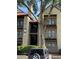Exterior view of a multi-story building, showcasing its balconies, red roof, and well-maintained landscaping at 234 Afton Sq # 205, Altamonte Springs, FL 32714