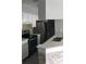 Modern kitchen with stainless steel appliances, white cabinetry, and a stylish backsplash at 234 Afton Sq # 205, Altamonte Springs, FL 32714
