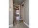 Hallway featuring ceramic tile floors leading into a bedroom with ceiling fan and window at 234 Afton Sq # 305, Altamonte Springs, FL 32714