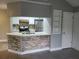 Kitchen featuring stainless steel appliances, white cabinetry, and breakfast bar with stone facade at 234 Afton Sq # 305, Altamonte Springs, FL 32714