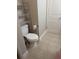 Compact toilet area featuring toilet, tile floor, and wall-mounted shelving at 236 Afton Sq # 309, Altamonte Springs, FL 32714