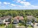 Stunning tile roof home boasts lush landscaping and beautiful architectural details in a well-maintained neighborhood at 2497 Heritage Green Ave, Davenport, FL 33837