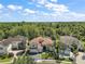 Stunning tile roof home boasts lush landscaping and beautiful architectural details in a well-maintained neighborhood at 2497 Heritage Green Ave, Davenport, FL 33837