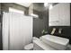 Bathroom featuring a dark tiled wall, a white vanity, and a shower with a white curtain at 2497 Heritage Green Ave, Davenport, FL 33837