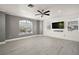 A spacious bedroom is brightened by natural light, ceiling fan, and modern vinyl floors at 2497 Heritage Green Ave, Davenport, FL 33837