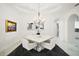Formal dining room features a modern chandelier and views to the kitchen at 2497 Heritage Green Ave, Davenport, FL 33837