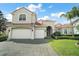 Beautiful two-story home features a tile roof, three-car garage and neatly manicured lawn at 2497 Heritage Green Ave, Davenport, FL 33837